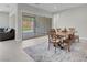 Light-filled dining area includes a modern table with bench seating and sliding glass doors to the backyard at 313 Forsyth Park St, Las Vegas, NV 89138
