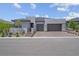 Striking modern home with three-car garage, desert landscaping, and stone accents at 313 Forsyth Park St, Las Vegas, NV 89138