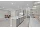 Open concept kitchen with stainless steel appliances, light gray cabinetry, a dining area, and a sleek island at 313 Forsyth Park St, Las Vegas, NV 89138