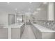 Modern kitchen boasts stainless steel appliances, light gray cabinetry, and a sleek island with white countertops at 313 Forsyth Park St, Las Vegas, NV 89138