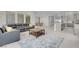 Spacious open-concept living room with a large sectional sofa, view of kitchen, and neutral tile flooring throughout at 313 Forsyth Park St, Las Vegas, NV 89138