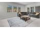Bright living room featuring a sectional sofa, a stylish rug, and abundant natural light through the large windows at 313 Forsyth Park St, Las Vegas, NV 89138
