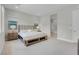 Comfortable main bedroom with bench at foot of bed, large windows and view of en suite bathroom at 313 Forsyth Park St, Las Vegas, NV 89138