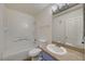 Bathroom featuring granite countertops, tub with shower and white tiling at 3318 N Decatur Blvd # 2129, Las Vegas, NV 89130