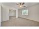 Carpeted bedroom with ceiling fan, closet with mirrored doors and bright light at 3318 N Decatur Blvd # 2129, Las Vegas, NV 89130