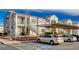 Exterior shot of an apartment complex featuring covered parking, staircases, and multiple units at 3318 N Decatur Blvd # 2129, Las Vegas, NV 89130