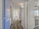Hallway view showcasing plank floors, blue cabinets, and access to the bedrooms at 3318 N Decatur Blvd # 2129, Las Vegas, NV 89130