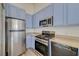 Kitchen showcasing stainless steel appliances, dishwasher, and plentiful blue cabinets at 3318 N Decatur Blvd # 2129, Las Vegas, NV 89130