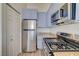 Well-lit kitchen with stainless steel appliances and ample blue cabinet space at 3318 N Decatur Blvd # 2129, Las Vegas, NV 89130