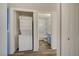Convenient laundry area features a stacked washer and dryer adjacent to the bathroom at 3318 N Decatur Blvd # 2129, Las Vegas, NV 89130