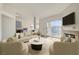Bright living room with fireplace, large sliding doors, and tan sectional sofa and chairs at 3318 N Decatur Blvd # 2129, Las Vegas, NV 89130