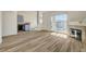 Bright living room with wood floors, fireplace, and sliding glass doors to the balcony at 3318 N Decatur Blvd # 2129, Las Vegas, NV 89130