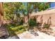 Cozy backyard with grass, pavers, and mature trees at 3408 Livia Ave, North Las Vegas, NV 89031