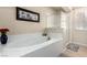 Bright bathroom with a soaking tub and glass enclosed shower at 3408 Livia Ave, North Las Vegas, NV 89031