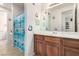 Picture of the bathroom that features a wooden vanity, mirror, and shower at 3408 Livia Ave, North Las Vegas, NV 89031