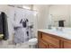 Small bathroom with a dog theme shower curtain, vanity and medicine cabinet at 3408 Livia Ave, North Las Vegas, NV 89031