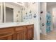 View of a bathroom with a wooden vanity and penguin decorations at 3408 Livia Ave, North Las Vegas, NV 89031