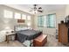 Inviting bedroom with a ceiling fan, natural light, and neutral decor at 3408 Livia Ave, North Las Vegas, NV 89031