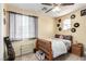 Cozy bedroom featuring a ceiling fan, vinyl record decor, and lots of natural light at 3408 Livia Ave, North Las Vegas, NV 89031