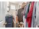 Messy walk-in closet with boxes and hanging clothes providing lots of storage at 3408 Livia Ave, North Las Vegas, NV 89031