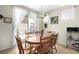 Cozy dining area with a wooden table, seating for six, and natural light from the sliding glass doors at 3408 Livia Ave, North Las Vegas, NV 89031