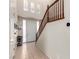 Bright entryway with tiled floor, staircase, and natural light from transom windows at 3408 Livia Ave, North Las Vegas, NV 89031