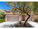Charming two-story home featuring a tile roof, stone accents, and a two-car garage at 3408 Livia Ave, North Las Vegas, NV 89031