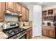 Galley kitchen featuring stainless steel appliances, granite countertops, and ample cabinet space at 3408 Livia Ave, North Las Vegas, NV 89031