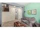Spacious living room featuring a comfortable couch, neutral paint, and staircase at 3408 Livia Ave, North Las Vegas, NV 89031
