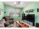 Comfortable living room with plush seating, large TV, and neutral decor at 3408 Livia Ave, North Las Vegas, NV 89031