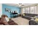 Cozy living room with plush seating, ceiling fan, and large windows at 3408 Livia Ave, North Las Vegas, NV 89031