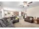 Open concept living area with comfortable sofas and view of the kitchen at 3408 Livia Ave, North Las Vegas, NV 89031