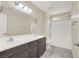 This bathroom features a double sink, a bathtub with a shower, tile floors, and neutral walls at 3638 Via Messina, Henderson, NV 89052