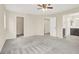 A spacious bedroom with neutral walls, grey carpeting, two doorways, and a ceiling fan with a light fixture at 3638 Via Messina, Henderson, NV 89052