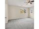 This neutral bedroom features plush gray carpeting, a ceiling fan, two windows, and neutral walls at 3638 Via Messina, Henderson, NV 89052