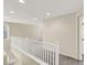 This hallway area features neutral walls, plush gray carpet, white railings, and recessed lighting, creating a serene and inviting transition at 3638 Via Messina, Henderson, NV 89052