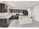 Modern kitchen features dark cabinets, granite countertops, and stainless steel appliances at 3638 Via Messina, Henderson, NV 89052