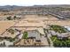 Broad aerial perspective featuring a desert home, pool, and sprawling desert terrain at 3955 W Jo Rae Ave, Las Vegas, NV 89141