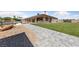 Expansive backyard featuring lush lawn, pool, patio and stone pathway for ultimate relaxation at 3955 W Jo Rae Ave, Las Vegas, NV 89141