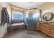 A luxurious bathroom showcasing a soaking tub and glass-enclosed shower at 3955 W Jo Rae Ave, Las Vegas, NV 89141