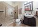 Bathroom featuring glass enclosed shower, single sink, and neutral colored tile at 3955 W Jo Rae Ave, Las Vegas, NV 89141