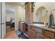 Bathroom featuring double sinks, granite counters, and a view into a bedroom at 3955 W Jo Rae Ave, Las Vegas, NV 89141
