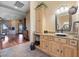 Bathroom with granite countertops, wooden cabinets, and a view into the living room at 3955 W Jo Rae Ave, Las Vegas, NV 89141