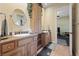 Bathroom with double sinks, granite countertops, and an entrance to another room with gym equipment at 3955 W Jo Rae Ave, Las Vegas, NV 89141