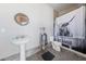 Unique bathroom with pedestal sink, toilet, shower and quirky Highland Cow themed shower curtain at 3955 W Jo Rae Ave, Las Vegas, NV 89141