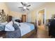 Bright bedroom with hardwood floors, a ceiling fan, and an ensuite bathroom entrance at 3955 W Jo Rae Ave, Las Vegas, NV 89141