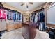 Large walk-in closet with a central island, custom drawers, hanging racks and shelving at 3955 W Jo Rae Ave, Las Vegas, NV 89141