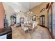 An elegant dining room with a chandelier and seating for eight, featuring tile flooring at 3955 W Jo Rae Ave, Las Vegas, NV 89141