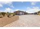 Home exterior with paver driveway, three car garage, and desert landscaping at 3955 W Jo Rae Ave, Las Vegas, NV 89141