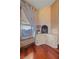 Elegant fireplace with a tiled surround, window view, and hardwood floors at 3955 W Jo Rae Ave, Las Vegas, NV 89141